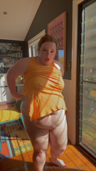 804438694_watch-me-squeeze-into-my-tight-orange-dress-after-being-in-t_0.mp4